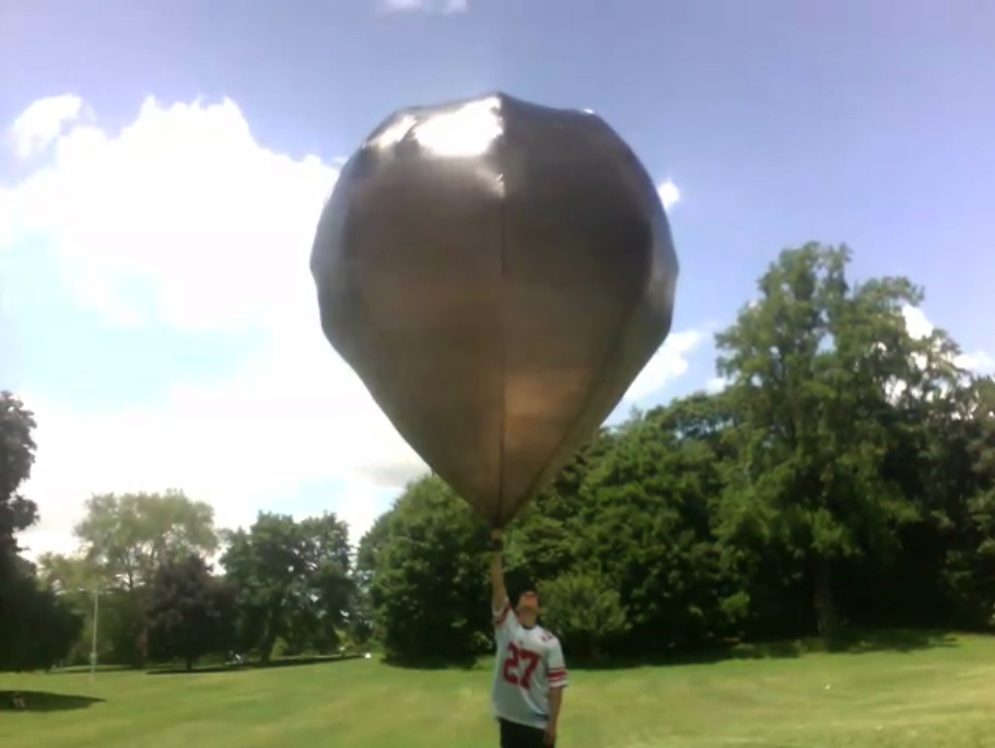 Jake holding a 10' sphere solar balloon