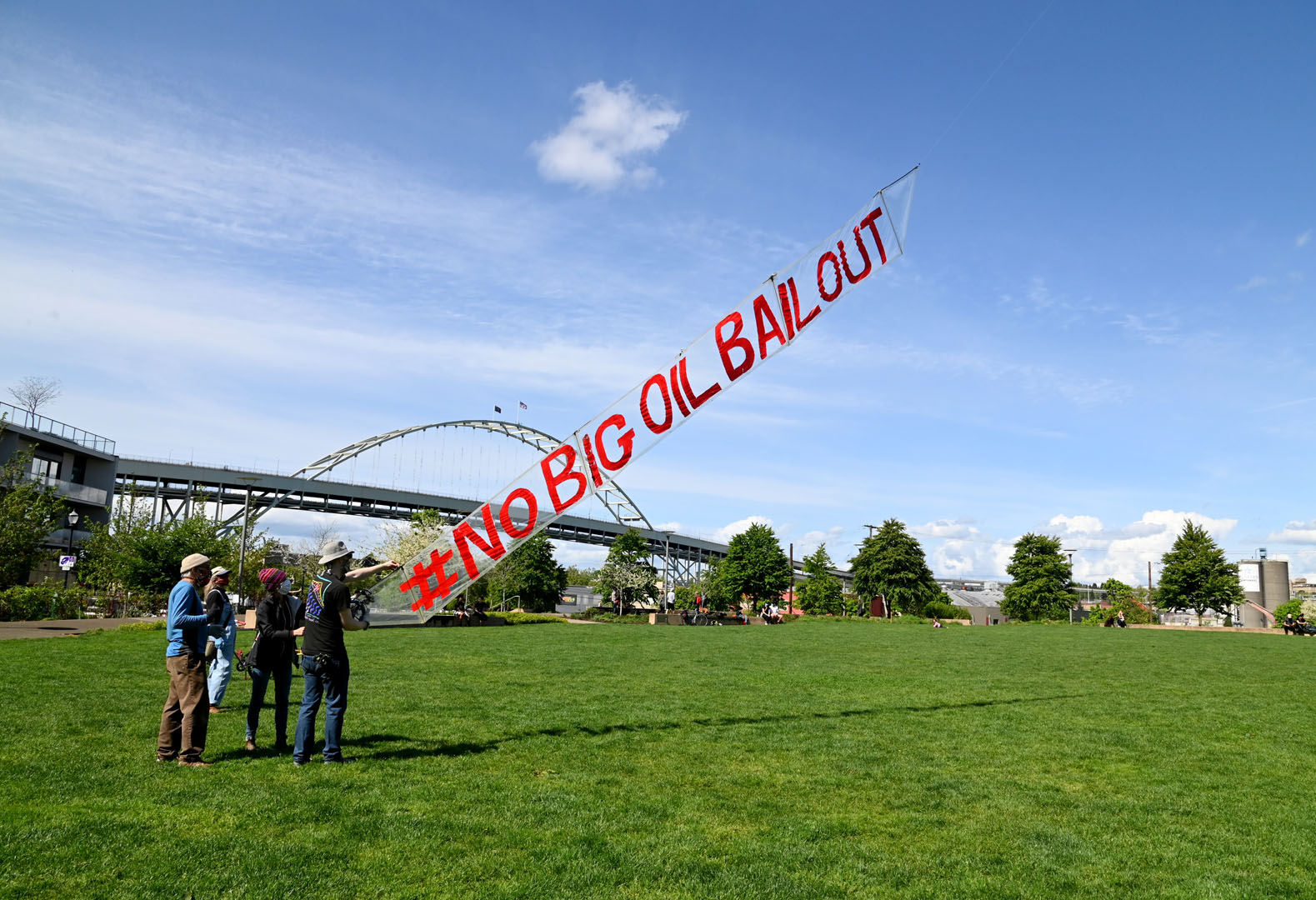 No Big Oil Bailout banner with people launching, photo Mike Hastie